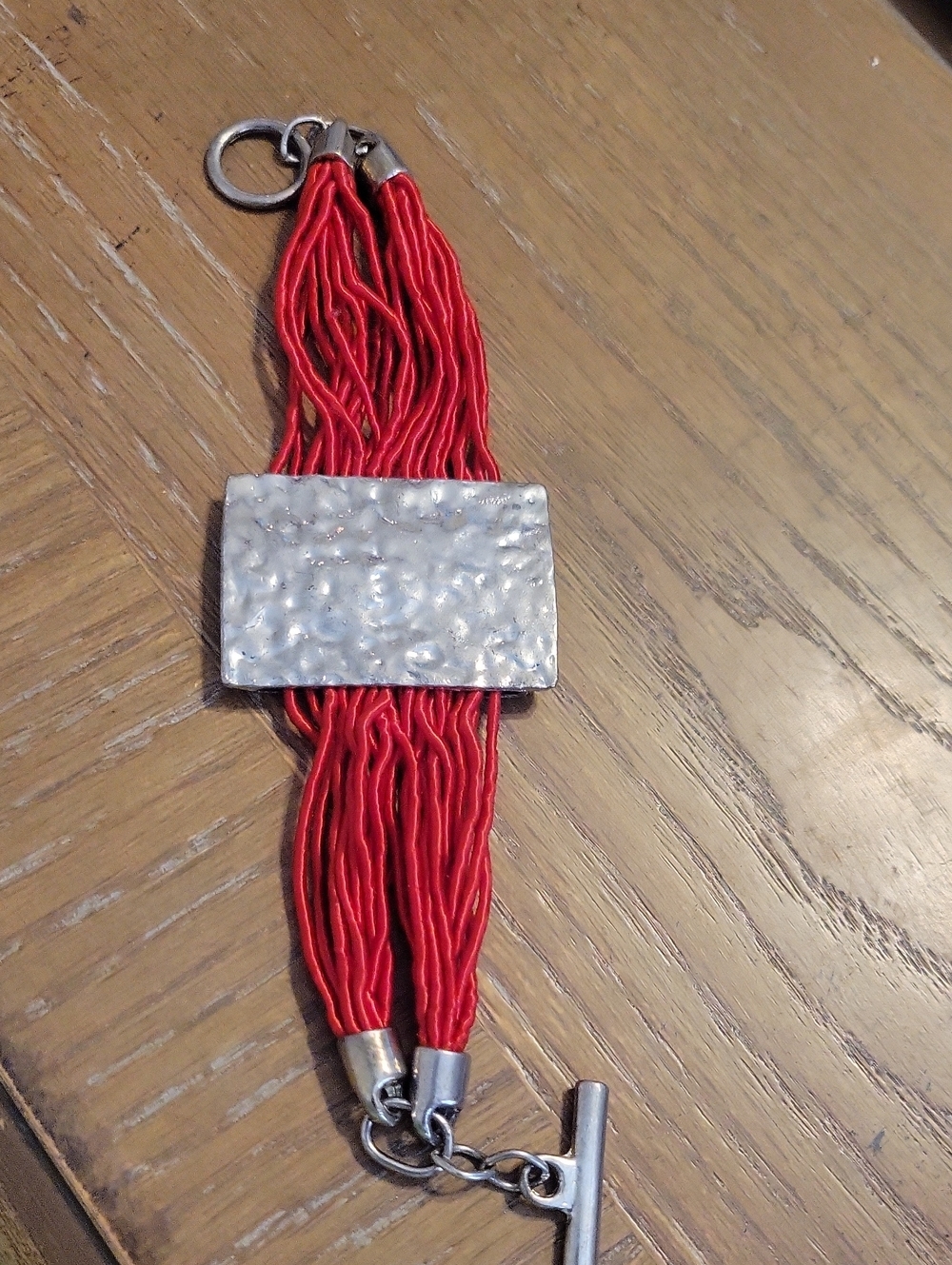 Red Multi-Strand Statement Bracelet with Hammered Silver tone Plate